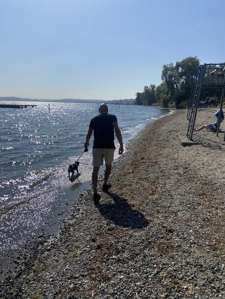 Rachid walking dog on the beach