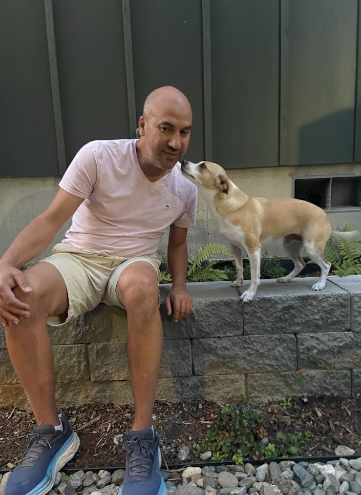 Rachid with tan corgi outdoors